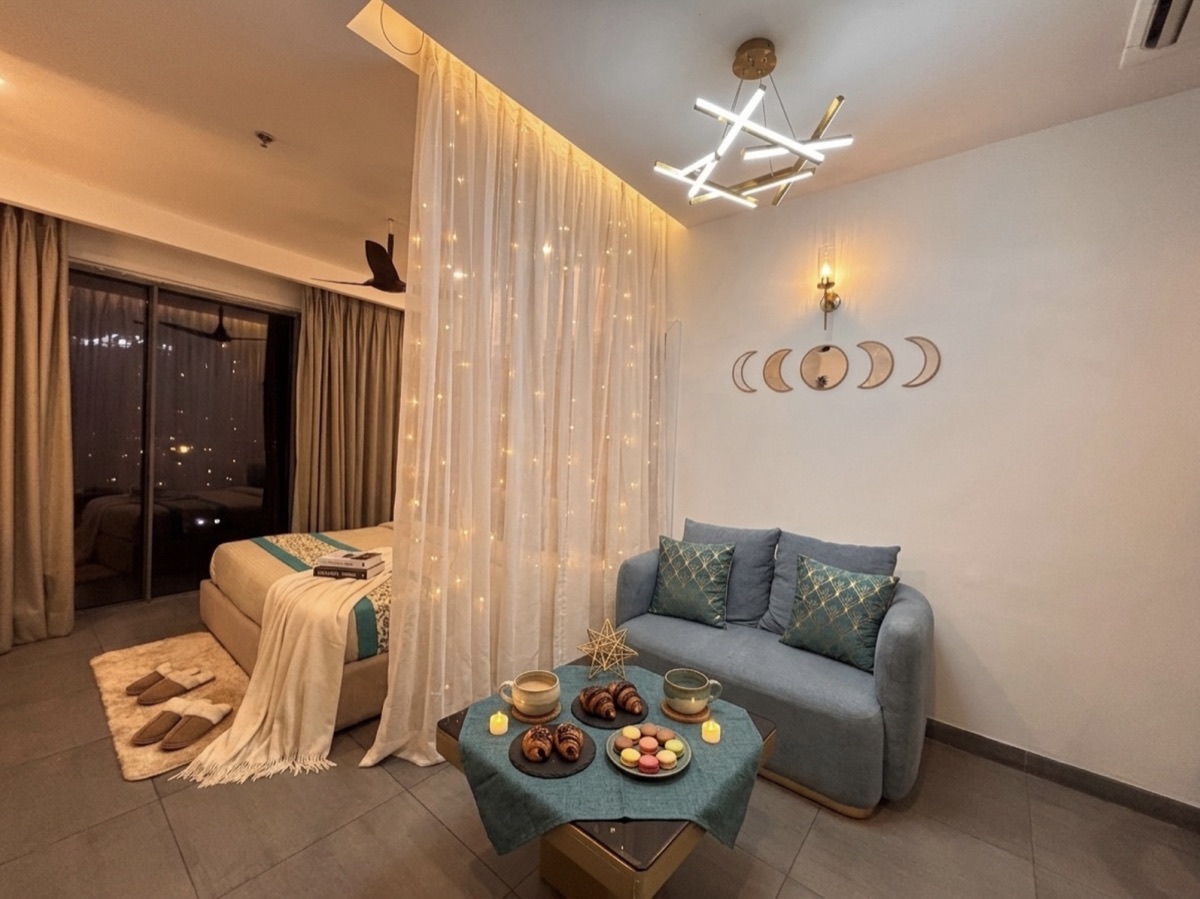 Studio living space glowing with fairy lights and evening treats