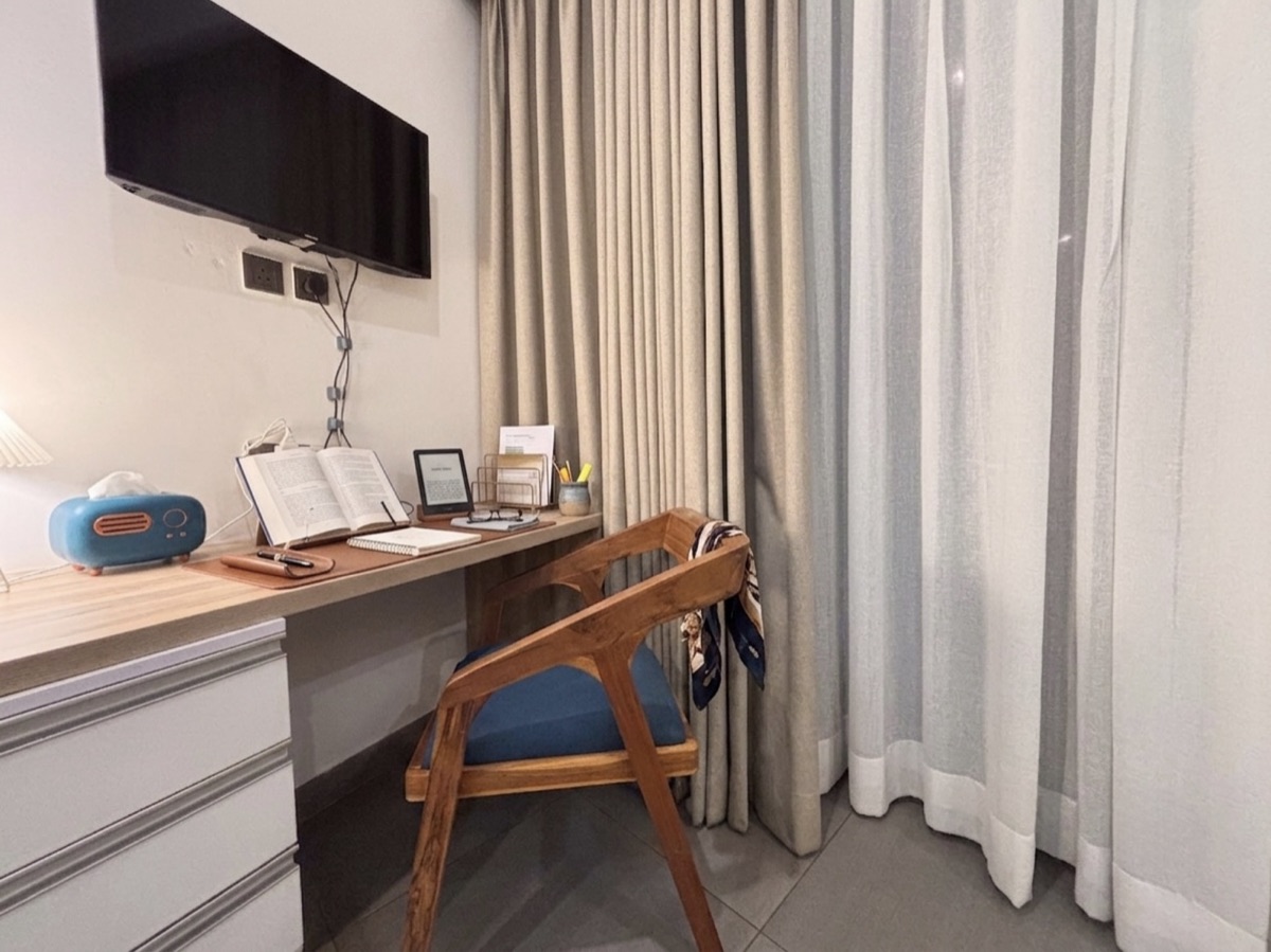 Work-friendly desk with a smart TV and city-view window